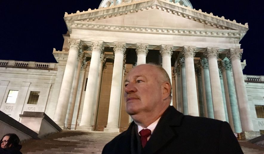 West Virginia Education Association president Dale Lee watches speakers during a candlelight vigil Wednesday, Feb. 13, 2019, outside the state Capitol in Charleston, W.Va. Inside, lawmakers continued to debate a complex education bill opposed by teachers. (AP Photo/John Raby)