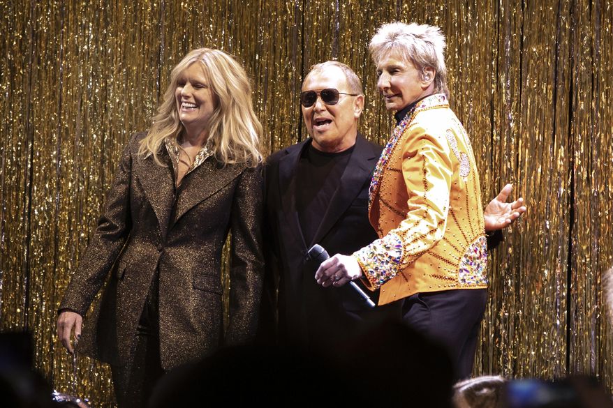 Designer Michael Kors, center, is joined by model Patti Hansen and Barry Manilow on stage after his collection was modeled during Fashion Week in New York, Wednesday, Feb. 13, 2019. (AP Photo/Richard Drew)