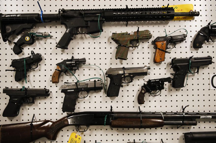 Seized firearms are displayed during a news conference Wednesday, Feb. 13, 2019, in Los Angeles. Federal prosecutors say they&#39;ve dealt a blow to two Los Angeles gangs that have ties to the Mexican Mafia after charging dozens of suspected members with racketeering and drug and gun violations. (AP Photo/Jae C. Hong)