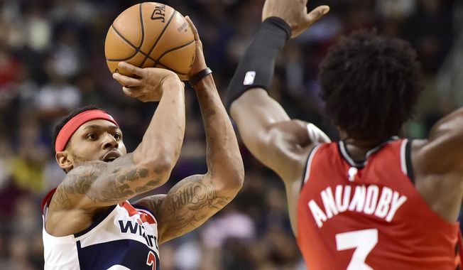 Washington Wizards guard Bradley Beal (3) shoots a 3-pointer over Toronto Raptors forward OG Anunoby (3) during the second half of an NBA basketball game Wednesday, Feb. 13, 2019, in Toronto. (Frank Gunn/The Canadian Press via AP) **FILE**