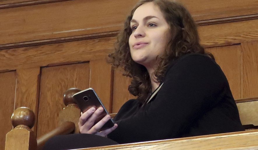 In this Wednesday, Feb. 13, 2019 photo, Rachel Sweet, a lobbyist for Planned Parenthood Great Plains, watches at the Kansas Senate debates a resolution condemning New York's new abortion law, at the Statehouse in Topeka, Kansas. She says, "I think this about political grandstanding." (AP Photo/John Hanna)