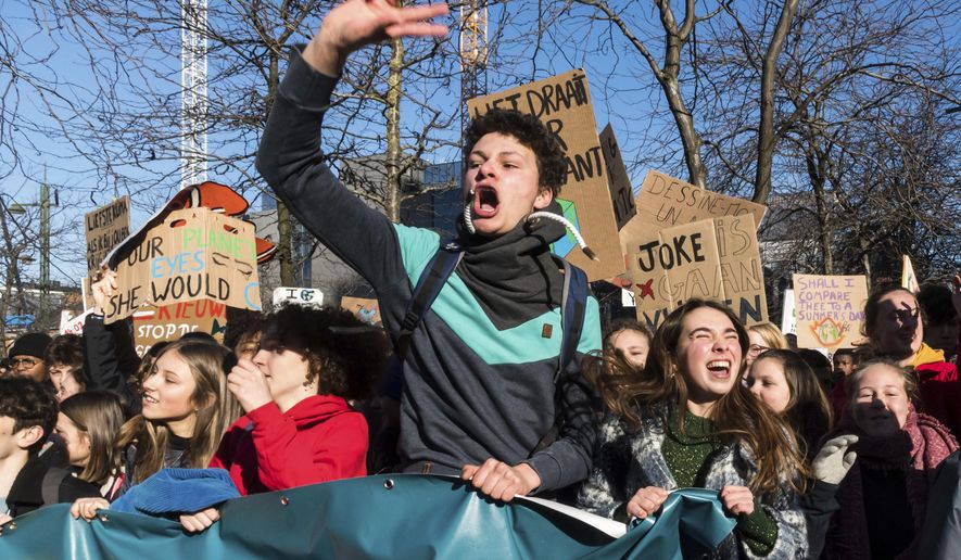 Students march during a climate change protest in Brussels, Thursday, Feb. 14, 2019. Thousands of teenagers in Belgium have skipped school for the sith week in a row in an attempt to push authorities into providing better protection for the world's climate. (AP Photo/Geert Vanden Wijngaert)