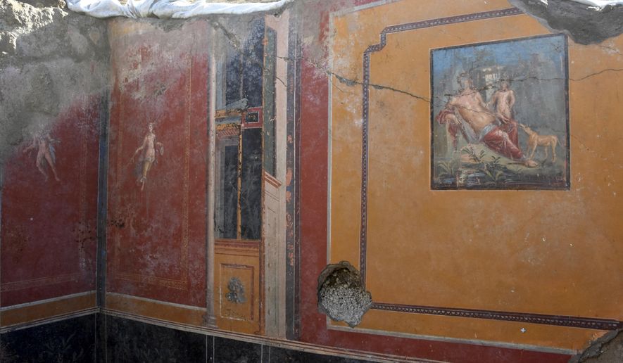 This undated photo provided Thursday, Feb. 14, 2019 by the Parco Archeologico di Pompei (Archeological Park of Pompei) shows the atrium of a house with a fresco portraying the mythological hunter Narcissus, right, in Pompeii, near Naples, Italy. Archaeologists have discovered a fresco in an ancient Pompeii residence that portrays the mythological hunter Narcissus, who fell in love with his own reflection, in a house where a fresco was found late last year depicting a sensual scene between the Roman god Jupiter disguised as a swan and Leda, a queen of Sparta from Greek mythology. (Parco Archeologico di Pompei via AP)