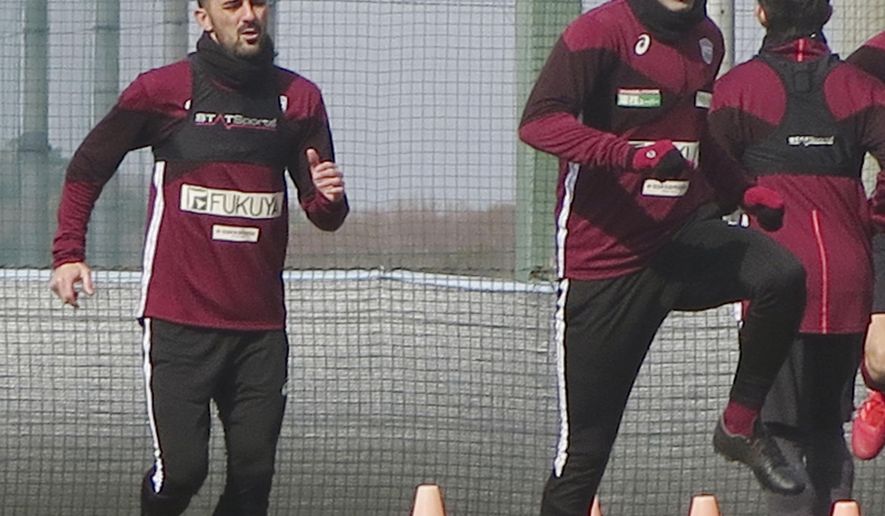 In this Jan. 21, 2019, photo, Vissel Kobe&#39;s Andres Iniesta, right, and David Villa, left, warm up during their team&#39;s training in Kobe, western Japan. Iniesta is hoping the addition of former Barcelona teammate Villa will lead to bigger and better things for his Japanese soccer team this season. (Kyodo News via AP)