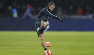 Real midfielder Gareth Bale shoots the ball as warming up during the first leg, round of sixteen, Champions League soccer match between Ajax and Real Madrid at the Johan Cruyff ArenA in Amsterdam, Netherlands, Wednesday Feb. 13, 2019. (AP Photo/Peter Dejong)