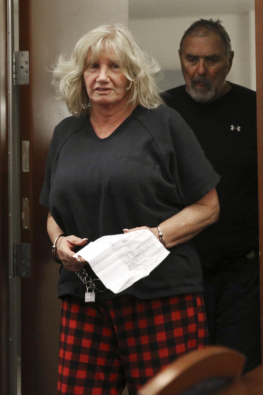 Patricia Chappuis, left, followed by her husband Marcel, appear in court for a hearing at the Regional Justice Center in Las Vegas, Thursday, Feb. 14, 2019. Marcel Chappuis and his wife, Patricia, the owners of a rural Nevada boarding school for at-risk teens and adolescents have been arrested on multiple child endangerment charges alleging that they served tainted water to students living at the facility. (Erik Verduzco/Las Vegas Review-Journal via AP)