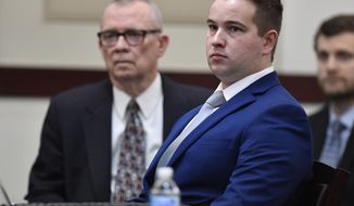 FILE - In this Jan. 5, 2019, file photo, Nashville Police Officer Andrew Delke sits with his attorney John M.L. Brown at the second day of his preliminary hearing at the Justice A.A. Birch Building in Nashville, Tenn. The attorney for Delke, a police officer charged with fatally shooting an armed black man is calling for legal discovery documents to be sealed from the public. (George Walker IV/The Tennessean via AP)
