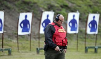 In this Jan. 30, 2019, photo, Sgt. Michael Hazellief, training supervisor, walks on the grounds where the &amp;quot;guardians&amp;quot; are participating in a training session to respond to active shooters in Okeechobee, Fla. Okeechobee is one of the Florida districts that have started training and arming non-instructional personnel in the aftermath of the Marjory Stoneman Douglas High School shooting. Authorities keep the identities of these guardians secret, citing security reasons. (AP Photo/Brynn Anderson)