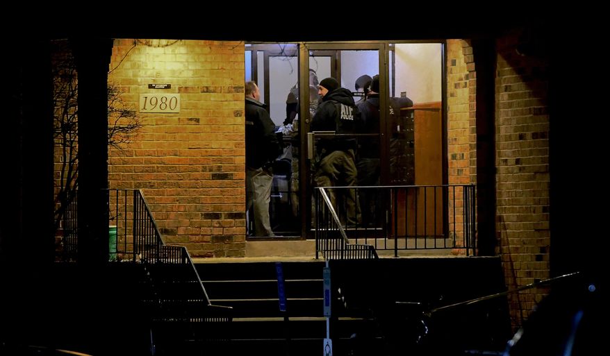 Investigators enter an apartment building Friday, Feb. 15, 2019, in Aurora, Ill., where a man who police say fatally shot several people and injured police officers at a manufacturing plant in Aurora is believed to have lived. (AP Photo/Matt Marton)