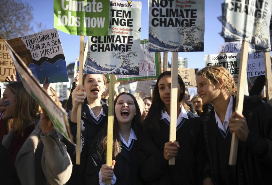 Students join the Youth Strike 4 Climate movement during a climate change protest near Parliament in London, Friday Feb. 15, 2019.  The demonstration is one many nationwide to demand action against climate change. (Nick Ansell/PA via AP)