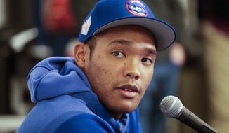 Chicago Cubs shortstop Addison Russell speaks at a press conference after a spring training baseball workout Friday, Feb. 15, 2019, in Mesa, Ariz. (AP Photo/Morry Gash)