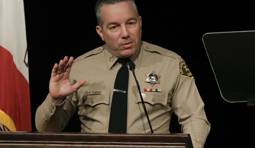 FILE - In this Dec. 3, 2018 file photo newly-elected Los Angeles County Sheriff Alex Villanueva speaks during a swearing-in ceremony in Monterey Park, Calif. Villanueva will limit when inmates in the county's jails can be transferred to federal authorities for deportation. Sheriff's Department spokeswoman Nicole Nishida said on Friday, Feb. 15, 2019, the agency will reduce the number of misdemeanor charges that can trigger an inmate's transfer. She could not immediately say which misdemeanor charges would no longer qualify. (AP Photo/Jae C. Hong, File)