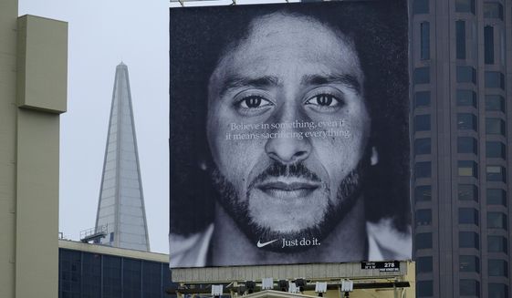 In this Sept. 5, 2018, file photo, a large billboard stands on top of a Nike store showing former San Francisco 49ers quarterback Colin Kaepernick, at Union Square in San Francisco. (AP Photo/Eric Risberg, File)