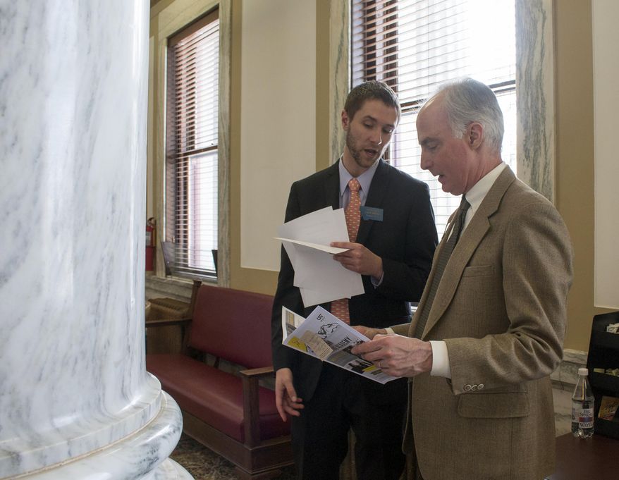 FILE - In this March 10, 2017 file photo, Rep. Zach Brown, D-Bozeman, left, speaks to fellow Rep. Jim Hamilton, D-Bozeman, after a session of the Montana Legislature in Helena, Mont. Rep. Brown is sponsoring a bill that would align state law with a U.S. Supreme Court ruling that found it unconstitutional to sentence most criminals under the age of 18 to life in prison without the possibility of parole, Friday, Feb. 15, 2019. (AP Photo/Bobby Caina Calvan, File)