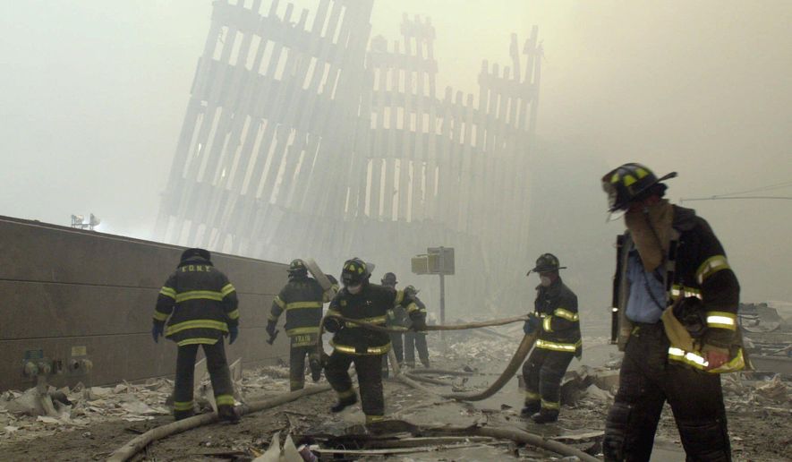 In this Sept. 11, 2001, file photo, with the skeleton of the World Trade Center twin towers in the background, New York City firefighters work amid debris on Cortlandt Street after the terrorist attacks. On Friday, Feb. 15, 2019, Rupa Bhattacharyya, the September 11th Victim Compensation Fund special master, announced that the compensation fund for victims of the Sept. 11, 2001, terror attacks will cut future payments by 50 to 70 percent because the fund is running out of money. (AP Photo/Mark Lennihan, File)