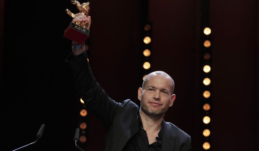 Director Nadav Lapid holds aloft the golden bear for best film for &#39;Synonyms&#39; onstage at the award ceremony of the 2019 Berlinale Film Festival in Berlin, Germany, Saturday, Feb. 16, 2019. (AP Photo/Markus Schreiber)