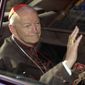 FILE - In this April 23, 2002 file photo Cardinal Theodore McCarrick of the Archdiocese of Washington, waves as he arrives at the Vatican in a limousine. On Saturday, Feb. 16, 2019 the Vatican announced Pope Francis defrocked former U.S. Cardinal Theodore McCarrick after Vatican officials found him guilty of soliciting for sex while hearing Confession.  (AP Photo/Andrew Medichini, file)