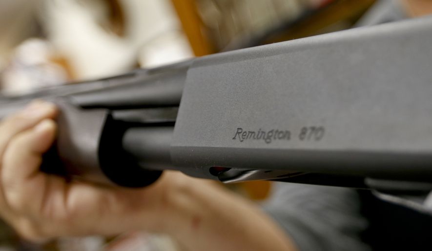 In this March 1, 2018, file photo, the Remington name is seen etched on a model 870 shotgun at Duke's Sport Shop in New Castle, Pa. Gun rights advocates say a mistake in an Ohio bill could inadvertently ban several types of legal guns and must be fixed. Gun advocates say a misplaced paragraph in the bill unintentionally lumped a variety of long guns into a prohibited category. They say lawmakers should fix the problem before the law takes effect March 28, 2019. (AP Photo/Keith Srakocic, File)