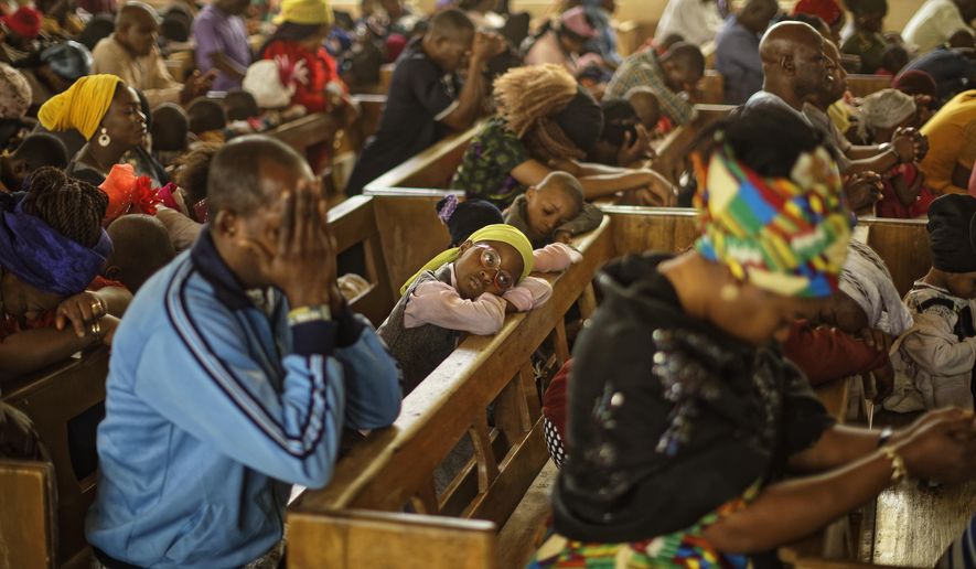 Churchgoers pray during a morning service at the Saint Charles Catholic Church, the site of a 2014 bomb attack blamed on Islamic extremist group Boko Haram, in the predominantly-Christian neighborhood of Sabon Gari in Kano, northern Nigeria Sunday, Feb. 17, 2019. With the leading contenders both northern Muslims, Nigeria&#x27;s presidential contest has been largely free of the religious pressures that marked the 2015 vote, but the Christian vote is bound to be decisive in a race that could sweep the incumbent out of power. (AP Photo/Ben Curtis)