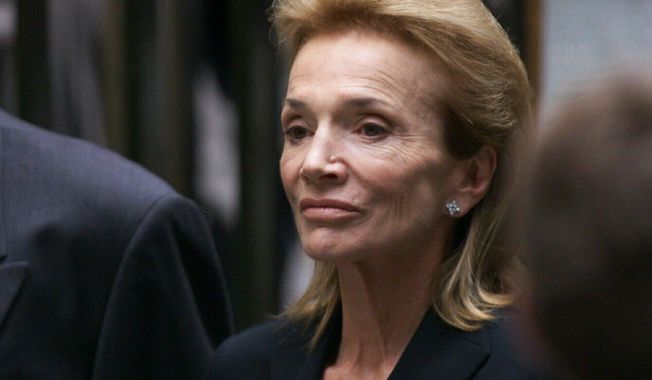 FILE - In this July 23, 1999 file photo, Lee Radziwill, sister of Jacqueline Kennedy Onassis, leaves the Church of St. Thomas More in New York. Radziwill, the stylish jet setter and socialite who made friends worldwide even as she bonded and competed with her older sister Jacqueline Kennedy, has died. She was 85. Anna Christina Radziwill told The New York Times her mother died Friday, Feb. 15, 2019, of what she described as natural causes. (AP Photo/Doug Mills, File)