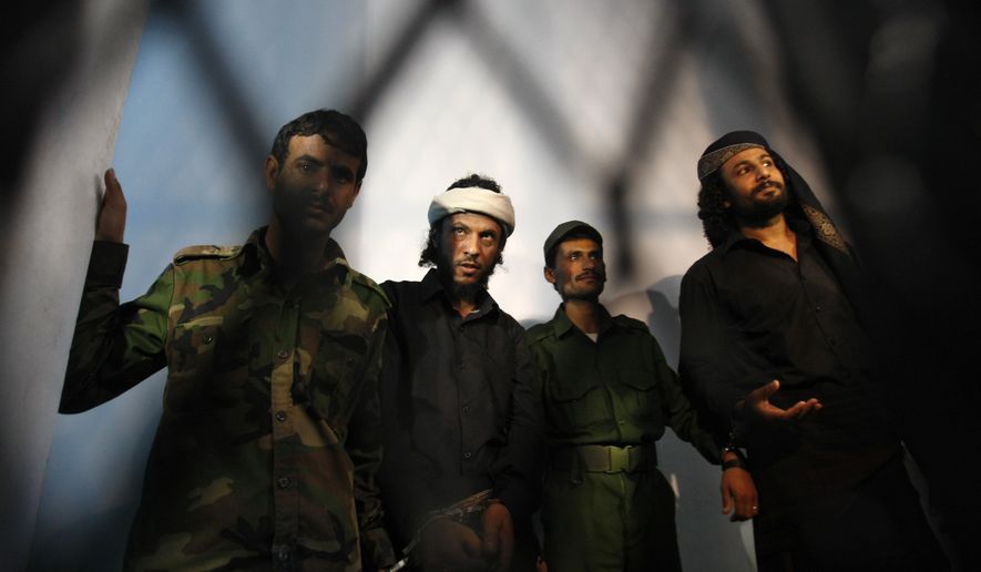 A group of suspected al Qaeda militants accused in the killing of an army general in a suicide bombing stand trial at a state security court in Sanaa, Yemen, in this April 22, 2014 file photo. (Associated Press)