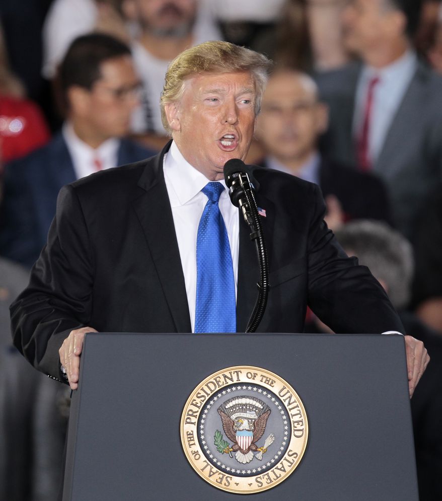 President Donald Trump speaks to a Venezuelan-American community at Florida International University in Miami, Monday, Feb. 18, 2019. (AP Photo/Luis M. Alvarez)