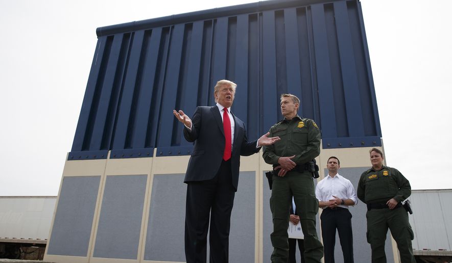 In this March 13, 2018, file photo, President Donald Trump talks with reporters as he reviews border wall prototypes in San Diego. (AP Photo/Evan Vucci, File)