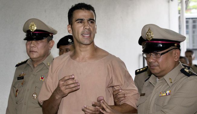 FILE -In this Monday, Feb. 4, 2019, file photo, detained Bahraini soccer player Hakeem al-Araibi arrives at the criminal court in Bangkok, Thailand. Australian Federal Police did not know Al-Araibi was a refugee who feared persecution in his homeland when the agency alerted Bahrain and Thailand that he was on a flight bound for Bangkok, a top police official said Monday. (AP Photo/Sakchai Lalit, File)