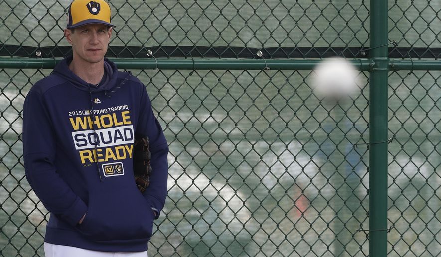Craig Counsell watches during a spring training baseball workout Sunday, Feb. 17, 2019, in Phoenix. (AP Photo/Morry Gash)