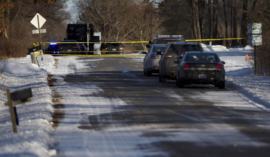 Kent County Sheriff personnel investigate the scene of a fatal shooting on Monday, Feb. 18, 2019, near Cedar Springs, Mich. Authorities say several people, including children, have been fatally shot at a property in western Michigan. (Neil Blake/MLive.com/The Grand Rapids Press via AP)