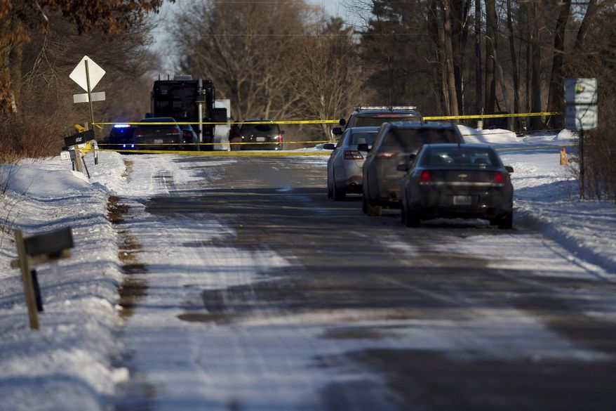 Kent County Sheriff personnel investigate the scene of a fatal shooting on Monday, Feb. 18, 2019, near Cedar Springs, Mich. Authorities say several people, including children, have been fatally shot at a property in western Michigan. (Neil Blake/MLive.com/The Grand Rapids Press via AP)