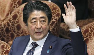 Japanese Prime Minister Shinzo Abe raises his hand during a parliamentary session at the Lower House in Tokyo, Monday, Feb. 18, 2019. Abe and his chief spokesman have declined to say if Abe nominated President Donald Trump for a Nobel Peace prize. Speaking in parliament on Monday, Abe said the Nobel committee has never in a half-century disclosed the identity of the person or groups behind such nominations. He said, “I thus decline comment.”(Kyodo News via AP)