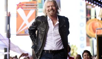 FILE - In this Oct. 16, 2018 file photo, British business magnate Richard Branson appears at a ceremony honoring him with a star on the Hollywood Walk of Fame, in Los Angeles. Branson said on Monday, Feb. 18, 2019, that he hopes that the concert that he is throwing for a humanitarian aid effort for Venezuela helps saves lives by raising funds for “much-needed medical help.” (Photo by Chris Pizzello/Invision/AP File)