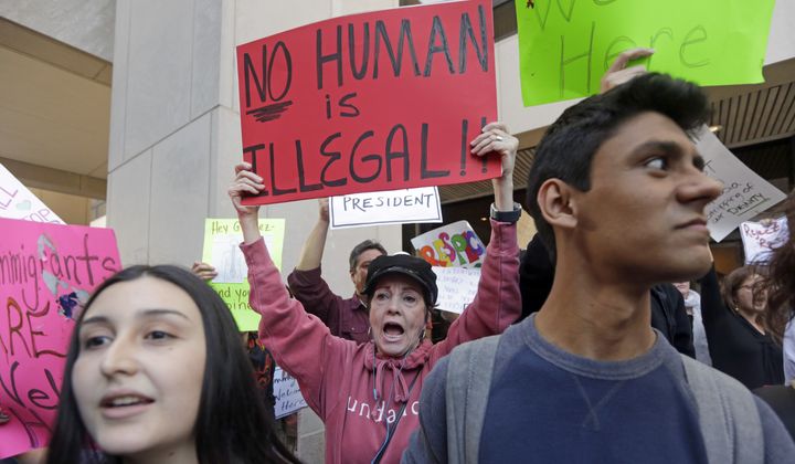 Demonstrators protest in downtown Miami, Tuesday, Jan. 31, 2017. A North Carolina student suspended for using the term &quot;illegal aliens&quot; in class has sued the school district, saying he was bullied and ostracized after being falsely &quot;branded as a racist.&quot; (AP Photo/Alan Diaz)