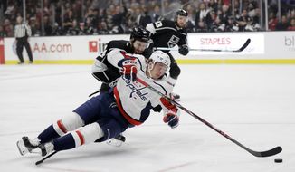 Washington Capitals&#39; Jakub Vrana, bottom, falls as he reaches for the puck in front of Los Angeles Kings&#39; Derek Forbort during the first period of an NHL hockey game Monday, Feb. 18, 2019, in Los Angeles. (AP Photo/Marcio Jose Sanchez) ** FILE **