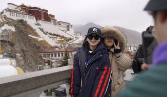 In this Feb. 9, 2019, photo released by Xinhua News Agency, tourists pose for souvenir photos in front of the Potala Palace in Lhasa, southwest China&#x27;s Tibet Autonomous Region. China is barring foreign travelers from Tibet over a period of several weeks that includes a pair of sensitive political anniversaries. Travel agencies contacted Wednesday, Feb. 20 said foreign tourists would not be allowed into the Himalayan region until April 1. (Jigme Dorje/Xinhua via AP)