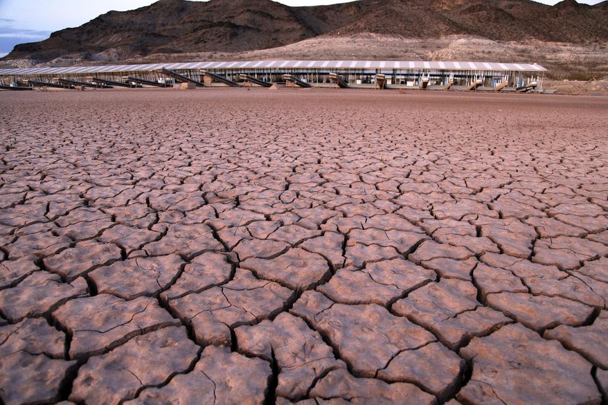 FILE - In this July 16, 2014 file photo, what was once a marina sits high and dry due to Lake Mead receding in the Lake Mead National Recreation Area in Arizona. Arizona won't have all the pieces of a Colorado River drought plan wrapped up by a March 4 deadline set by the federal government, state water officials said Tuesday, Feb. 19, 2019. It's the latest hurdle threatening the seven-state plan to take less water from the drought-starved Colorado River, which provides water for 40 million people and 5.5 million acres of farmland. (AP Photo/John Locher, File)