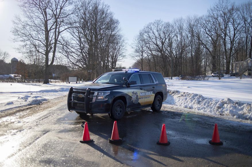 Kent County Sheriff personnel investigate the scene of a fatal shooting near the corner of 19 Mile NE and Division Avenue NE at a property on Monday, Feb. 18, 2019, near Cedar Springs, Mich. WOOD-TV reports Kent County Sheriff Michelle LaJoye-Young says authorities discovered the victims at a property near Cedar Springs, a community about 30 miles north of Grand Rapids. (Neil Blake/MLive.com/The Grand Rapids Press via AP)