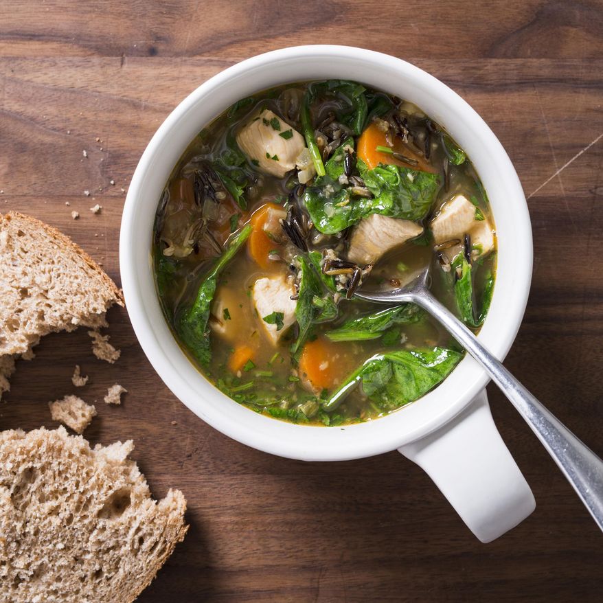 This undated photo provided by America's Test Kitchen in February 2019 shows Garlic Chicken and Wild Rice Soup in Brookline, Mass. This recipe appears in "The Complete Diabetes Cookbook." (Joe Keller/America's Test Kitchen via AP)