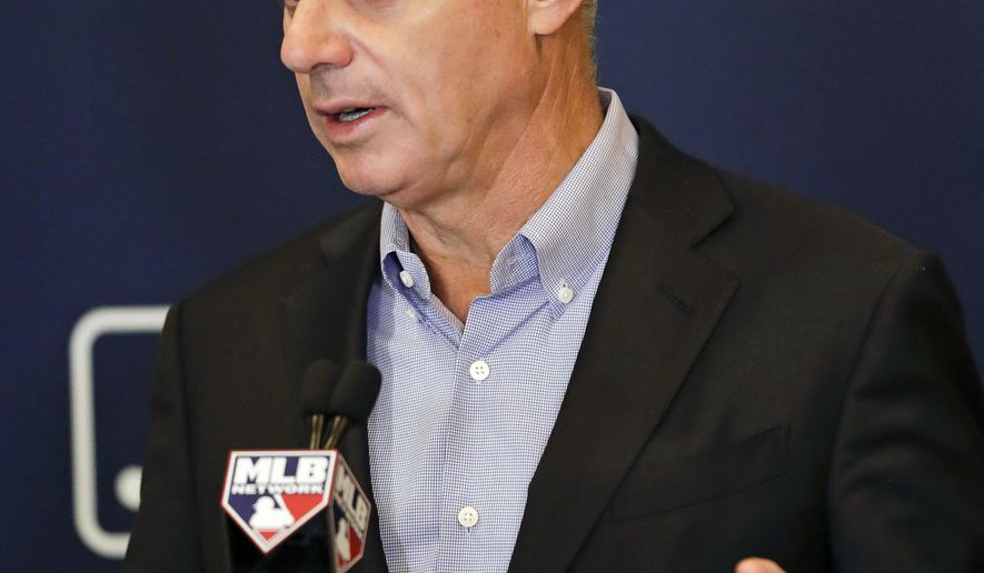 FILE - In this Feb. 8, 2019, file photo, Rob Manfred, commissioner of Major League Baseball, speaks during a news conference at owners meetings in Orlando, Fla. Players&#39; union head Tony Clark criticized baseball Commissioner Rob Manfred for blaming players’ demands for the slow free agent market and said an increasing number of teams make little effort to &amp;quot;justify the price of a ticket.&amp;quot; (AP Photo/John Raoux, File)