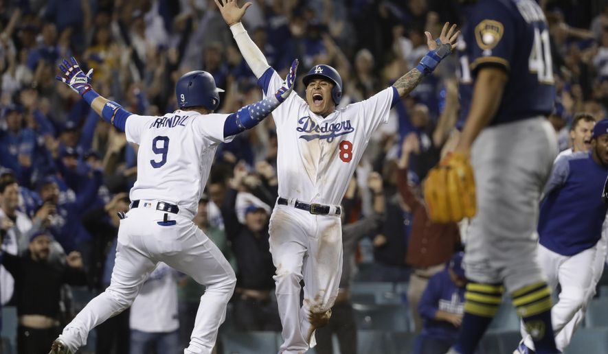 FILE - In this Oct. 16, 2018, file photo, Los Angeles Dodgers' Manny Machado (8) reacts after scoring on a Cody Bellinger walk-off hit during the 13th inning of Game 4 of the National League Championship Series baseball game against the Milwaukee Brewers, in Los Angeles. A person familiar with the negotiations tells The Associated Press that infielder Manny Machado has agreed to a $300 million, 10-year deal with the rebuilding San Diego Padres, the biggest contract ever for a free agent. The person spoke to the AP on condition of anonymity Tuesday, Feb. 19, 2019, because the agreement was subject to a successful physical and had not been announced. (AP Photo/Matt Slocum, File)
