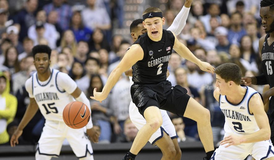 Georgetown guard Mac McClung, center, loses the ball against Villanova guard Collin Gillespie, right, and forward Saddiq Bey, left, during the first half of an NCAA college basketball game, Wednesday, Feb. 20, 2019, in Washington. (AP Photo/Nick Wass)