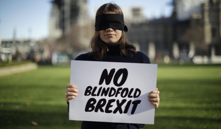 Lara Spirit, aged 22 from Chichester, a remain in the European Union supporter and member of the "Our Future, Our Choice" (OFOC) young people against Brexit organisation campaigning for a People's Vote second referendum on Britain's EU membership, poses for photographs after taking part in a protest against a blindfold Brexit on Parliament Square opposite the Houses of Parliament in London, Thursday, Feb. 14, 2019. Lara believes a People's Vote second referendum would be the best way forward. Britain voted to leave Europe in a referendum more than two years ago, but Parliament has been unable to agree on a withdrawal arrangement, prompting some calls for a delay or even a cancellation of the split. (AP Photo/Matt Dunham)