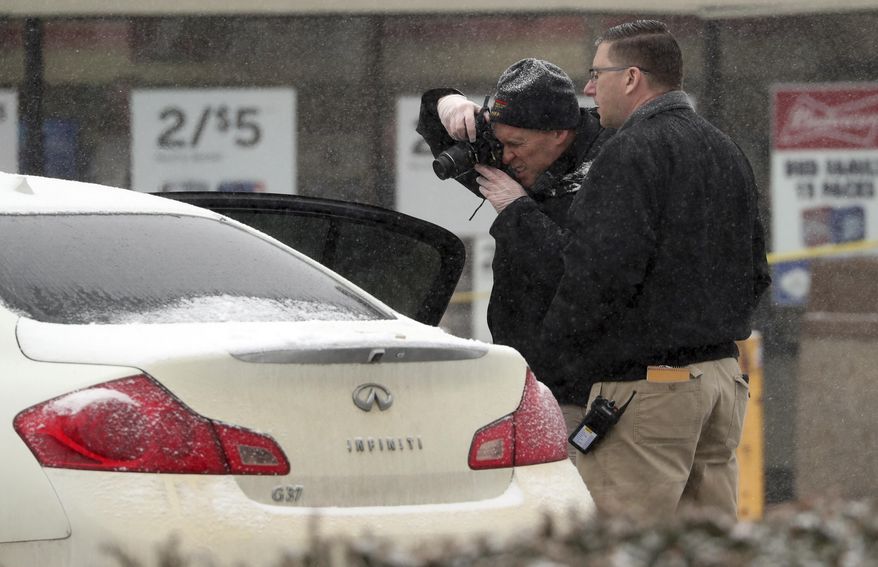Investigators make photos of a vehicle outside a convenience store in Garnerville, N.Y., Wednesday, Feb. 20, 2019, after the vehicle reportedly struck and injured several people, five of them children. Police say the driver of the vehicle has been taken into custody for questioning. (Peter Carr/The journal News via AP)