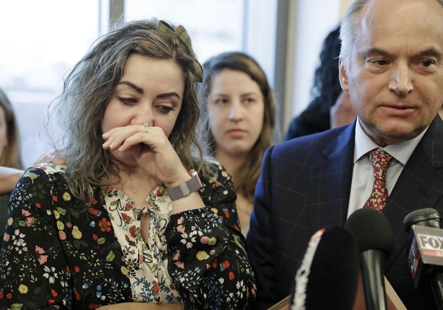 CORRECTS TO RECKLESS HOMICIDE, NOT CRIMINAL HOMICIDE- RaDonda Vaught, left, wipes away tears as her attorney, Peter Strianse, right, talks with reporters after a court hearing Wednesday, Feb. 20, 2019, in Nashville, Tenn. Vaught, a former nurse at Vanderbilt University Medical Center, is charged with reckless homicide after a medication error killed a patient. (AP Photo/Mark Humphrey)
