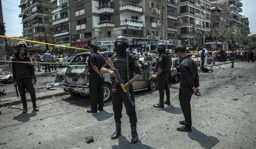 FILE -- In this June 29, 2015 file photo, Egyptian policemen stand guard at the site of a bombing that killed Egypt&#39;s top prosecutor, Hisham Barakat, who oversaw cases against thousands of Islamists, in Cairo. On Wednesday, Feb. 20, 2019 Egypt executed nine suspected Muslim Brotherhood members convicted of involvement in the 2015 assassination of Barakat, security officials said. The nine were found guilty of taking part in the bombing that killed Barakat, the first assassination of a senior official in Egypt in a quarter century. (AP Photo/Eman Helal, File)