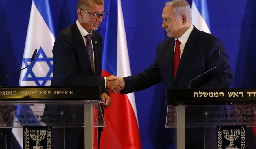 Czech Republic's Prime Minister Andrej Babis, left, Israeli Prime Minister Benjamin Netanyahu shake hands during a press conference after their meeting in Jerusalem, Tuesday, Feb. 19, 2019. (AP Photo/Ariel Schalit, Pool)