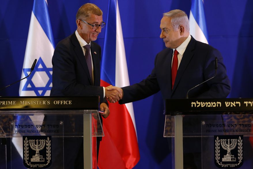 Czech Republic's Prime Minister Andrej Babis, left, Israeli Prime Minister Benjamin Netanyahu shake hands during a press conference after their meeting in Jerusalem, Tuesday, Feb. 19, 2019. (AP Photo/Ariel Schalit, Pool)