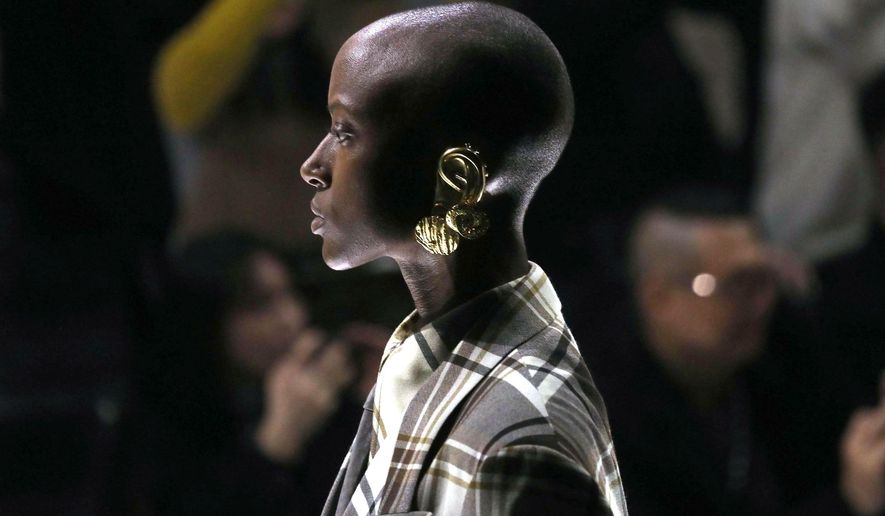 A model presents a creation by Gucci women's fall-winter 2019-2020 collection, during the Milan Fashion Week, in Milan, Italy, Wednesday, Feb. 20, 2019. (Matteo Bazzi/ANSA via AP)