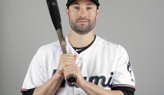 Neil Walker of the Miami Marlins baseball team poses Wednesday, Feb. 20, 2019, in Jupiter, Fla. While Manny Machado agreed to a pending $300 million, 10-year contract with San Diego and Bryce Harper is likely to top Giancarlo Stanton&#39;s record $325 million, 13-year deal, many less-than-superstar veterans have been routed on the free-agent market. Walker&#39;s salary dropped from $17.2 million to $2 million in two years. (AP Photo/Jeff Roberson)